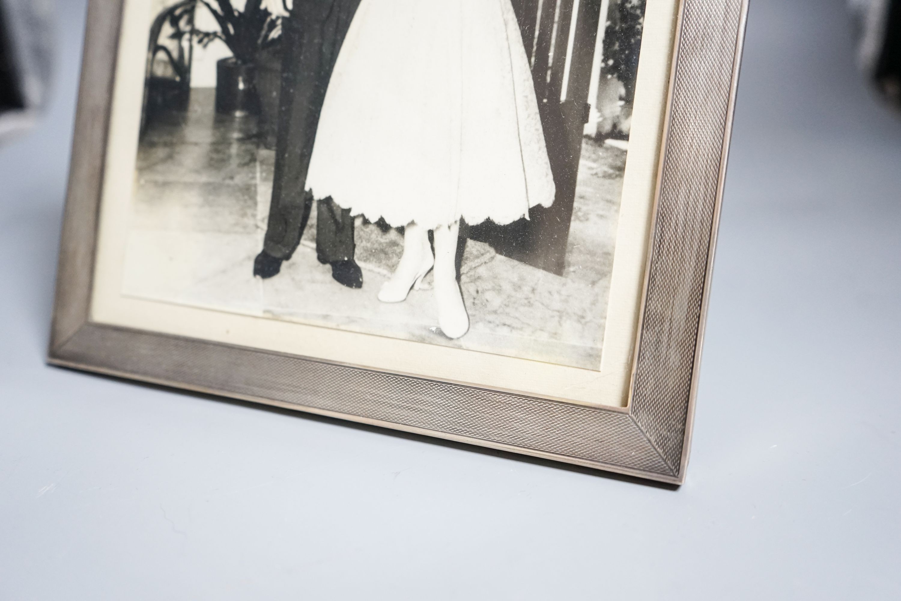 A George VI rectangular silver engine-turned photograph frame, Sanders & MacKenzie, Birmingham, 1945, 25.6cm. 25.5 x 20cm